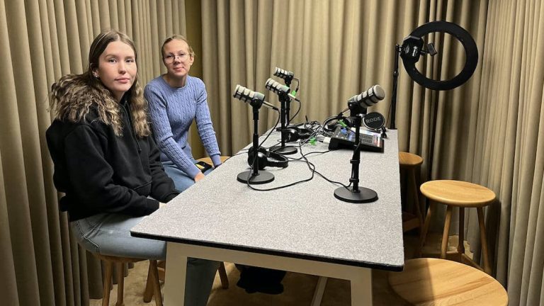 Två unga kvinnor i en poddstudio